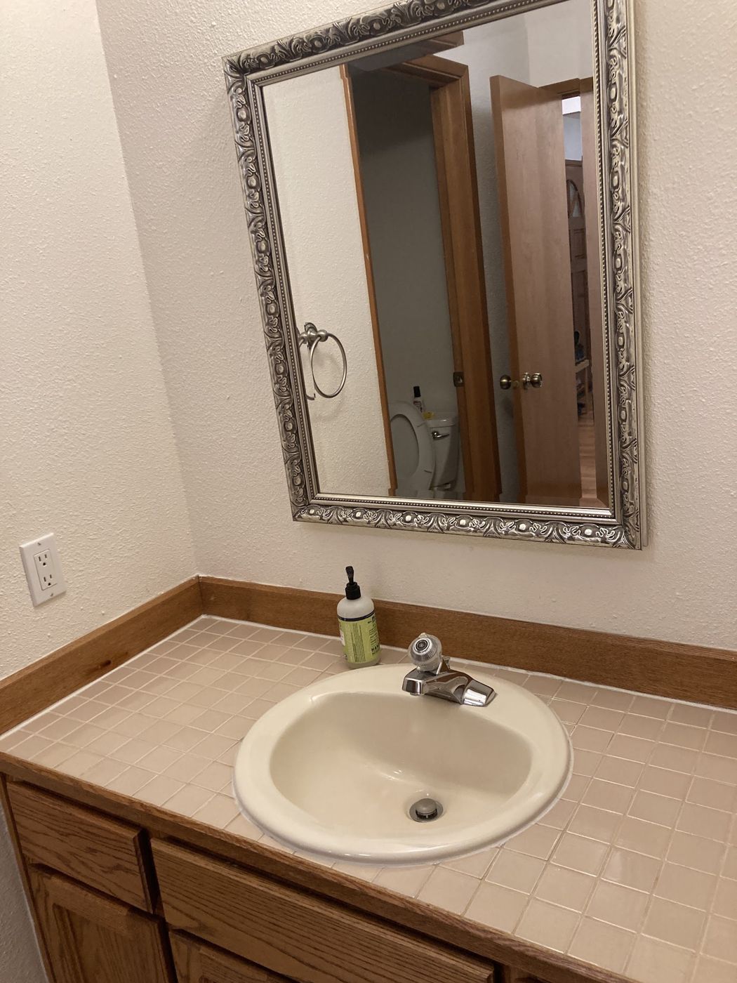 Clean bathroom vanity, sink and framed mirror